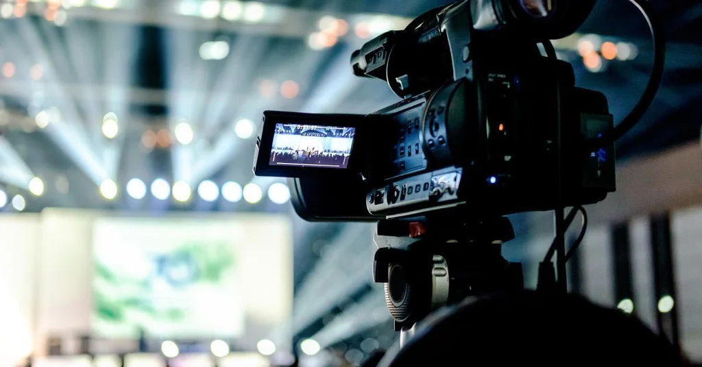Videographer filming at an event in Ibadan